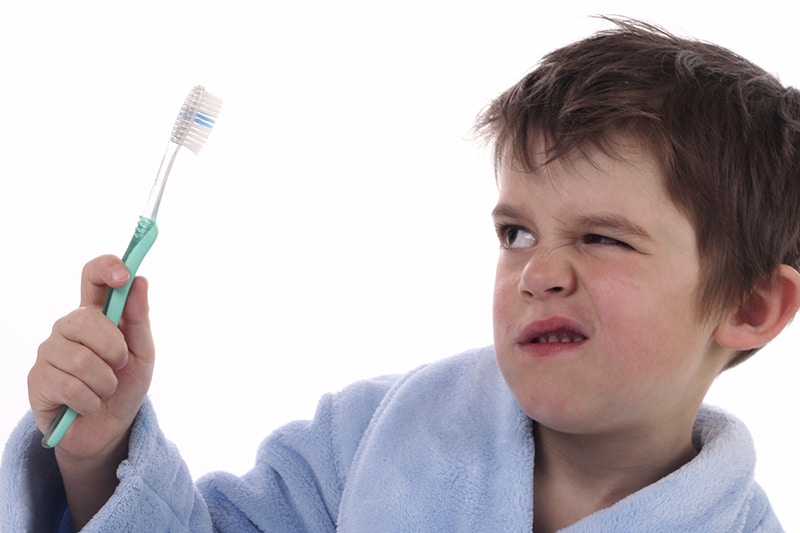 child looking at brush