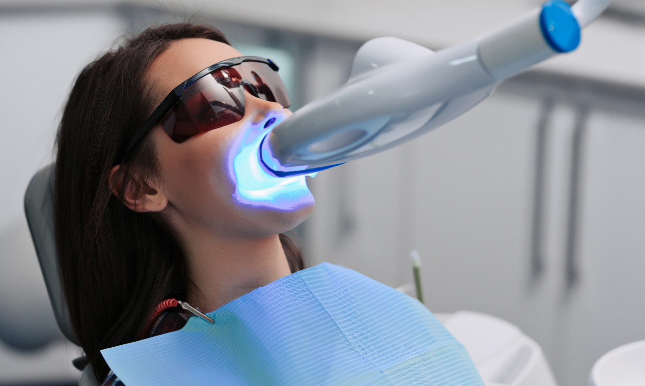 teeth whitening for woman bleaching of the teeth at dentist clinic